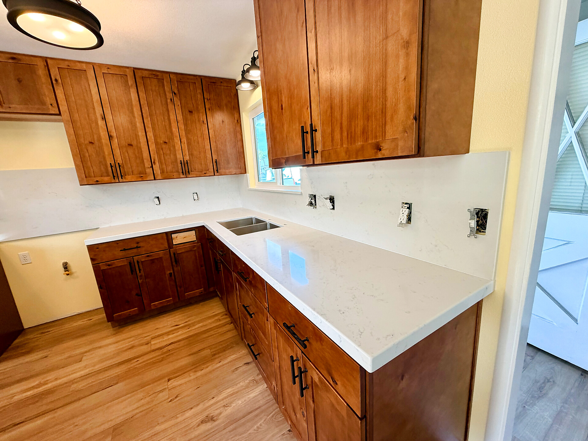 Quartz countertop install with knotty alder cabinets and stainless undermount sink
