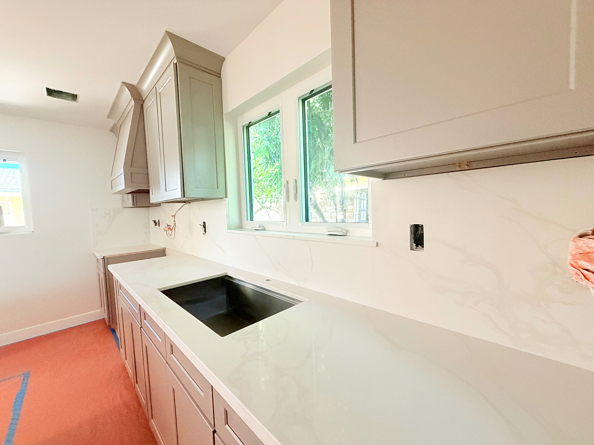 Calacatta quartz galley kitchen install with sage green cabinets